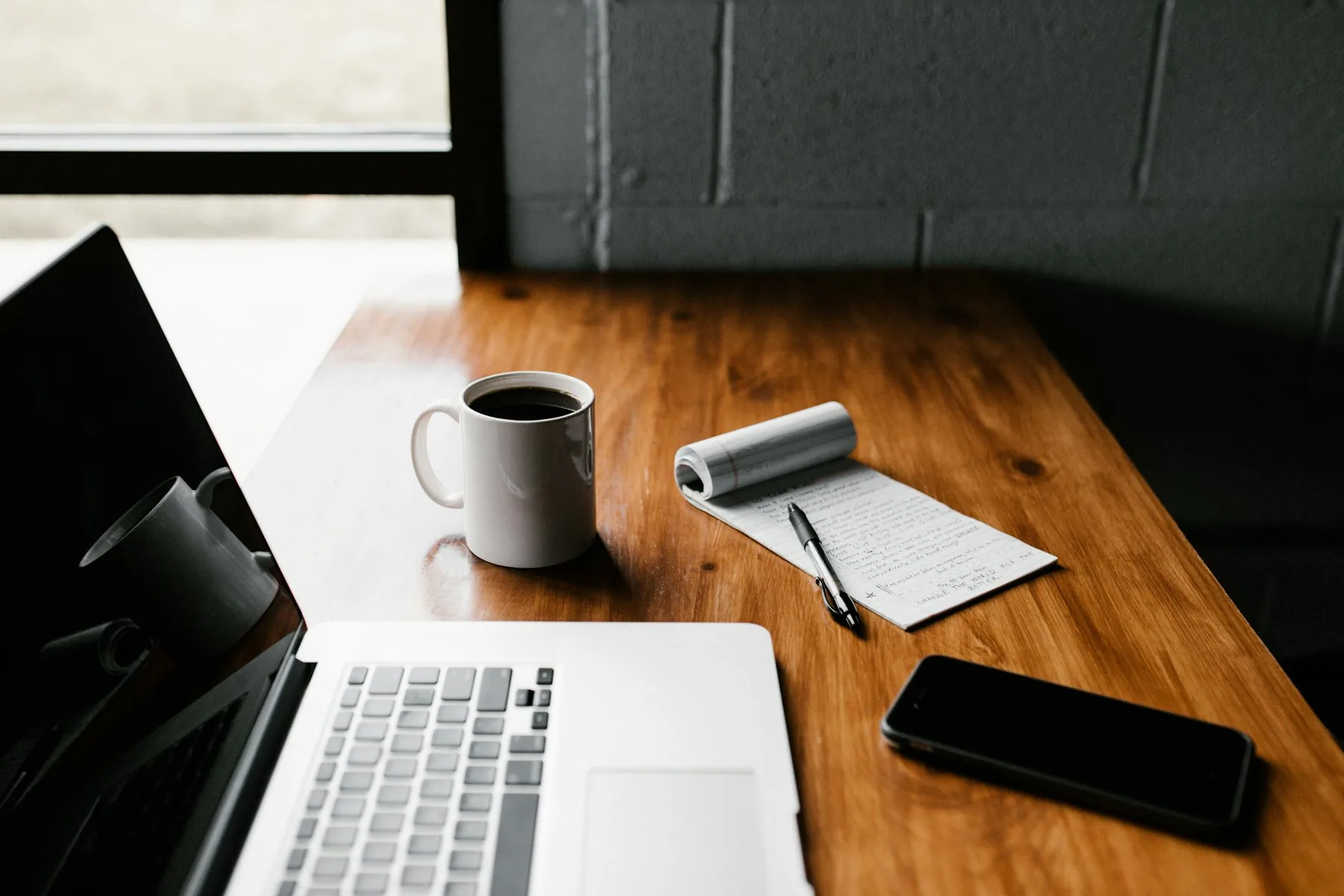 Notebook and laptop on a desk — the CODEVGROW automation blog